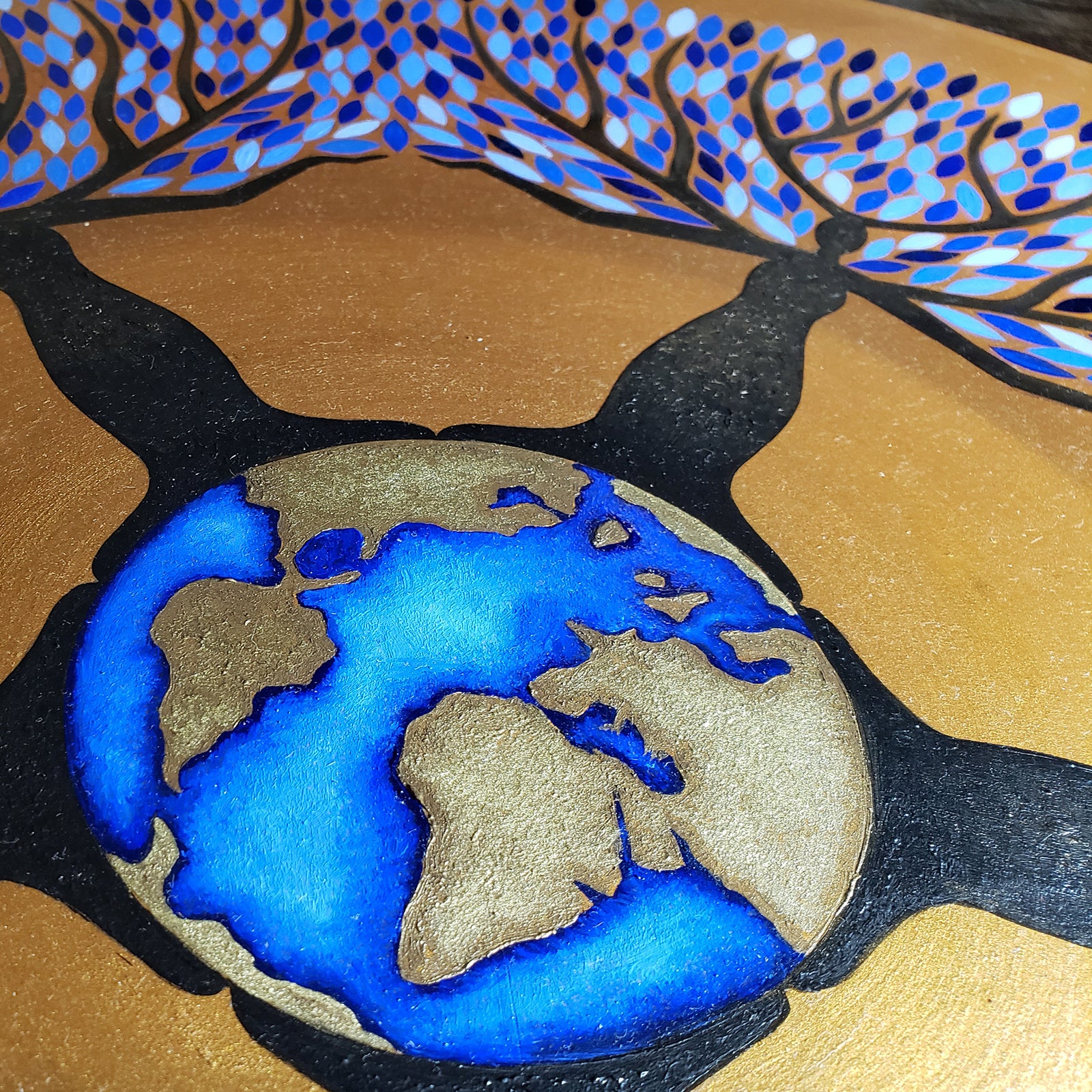 Equilibrium - Oil on Wood - 22 Diameter depicting interconnected human figures and a globe surrounded by blue and gold leaves.