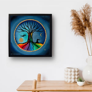 A framed print of a girl on a swing with rainbow tree and a meditator