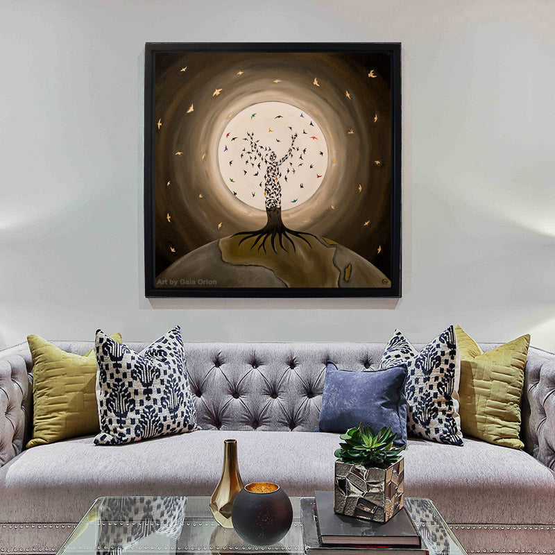 Flight of the Soul - Prints on canvas showing a tree figure with birds against a glowing moon, framed and hung above a sofa.