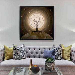 Flight of the Soul - Prints on canvas showing a tree figure with birds against a glowing moon, framed and hung above a sofa.