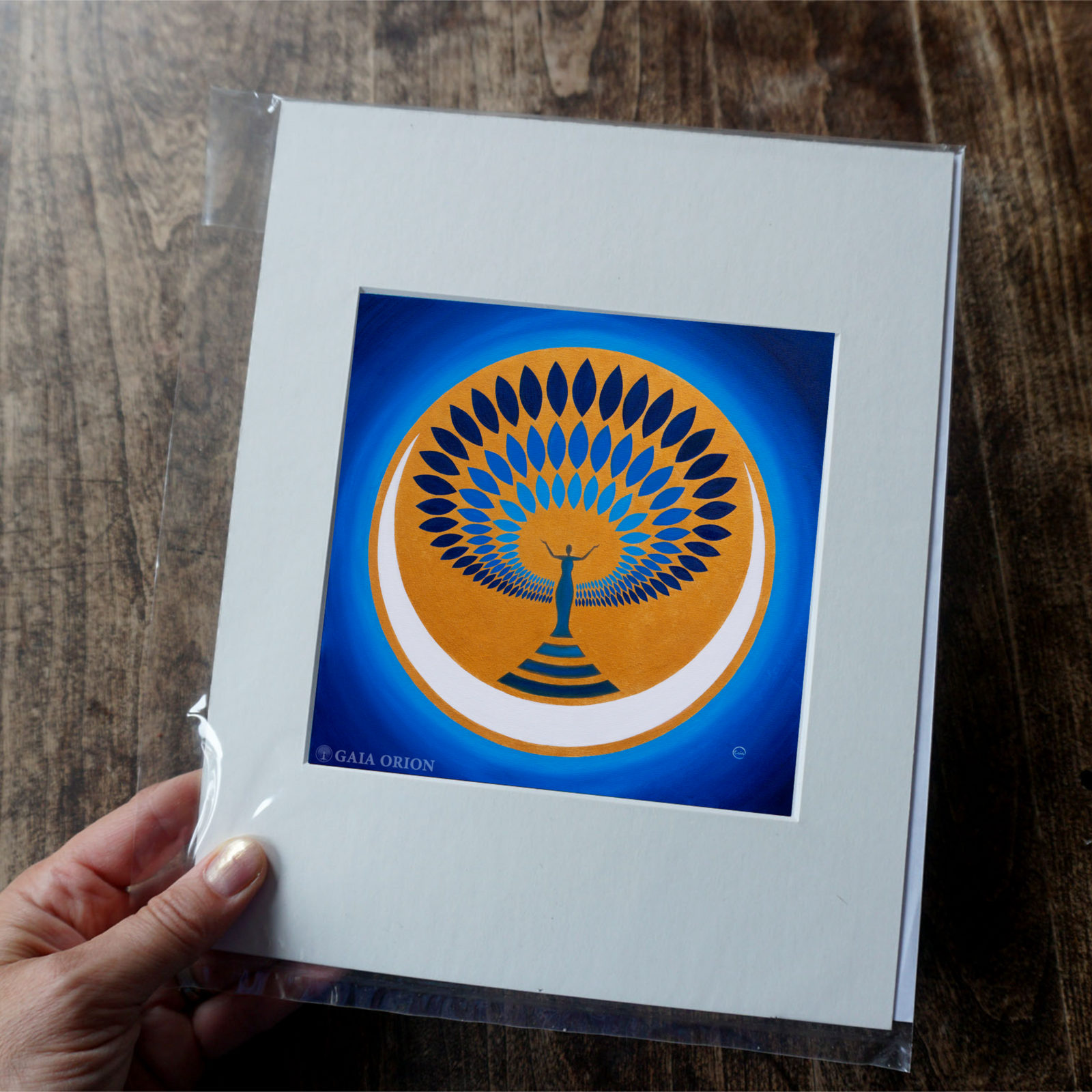 A blue and gold painting of  moon and a woman celebrating the sacred feminine