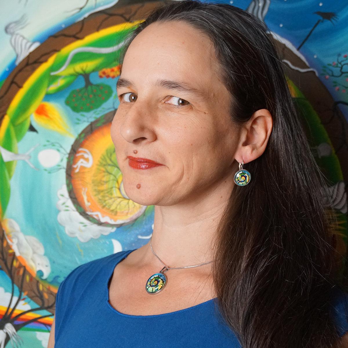 Her Journey Earrings featuring colorful spiral art on sterling silver medallions with durable glass dome protection.