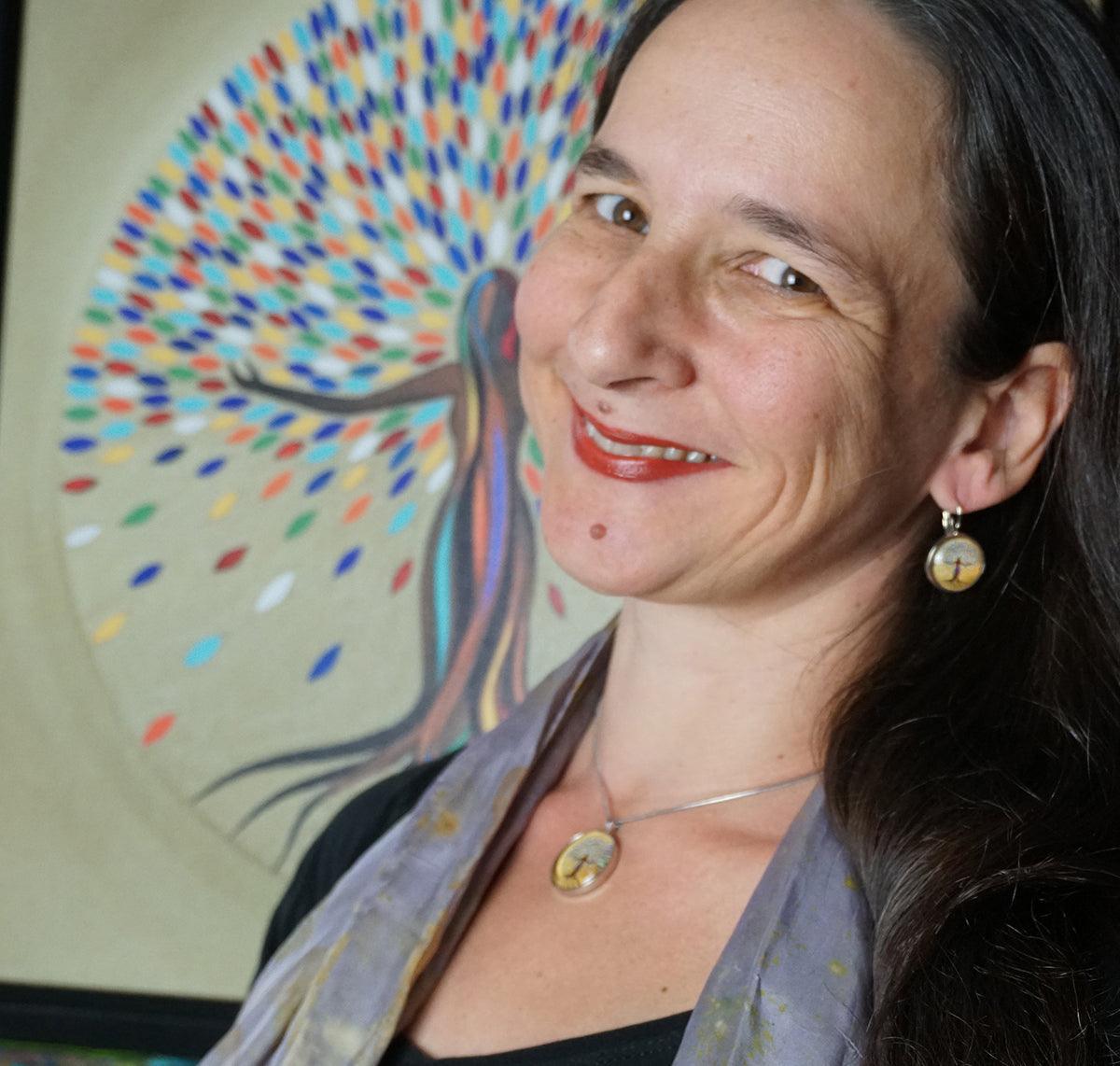 She Flourishes Earrings featuring colorful tree art on sterling silver medallions with durable glass dome, handmade in Canada.