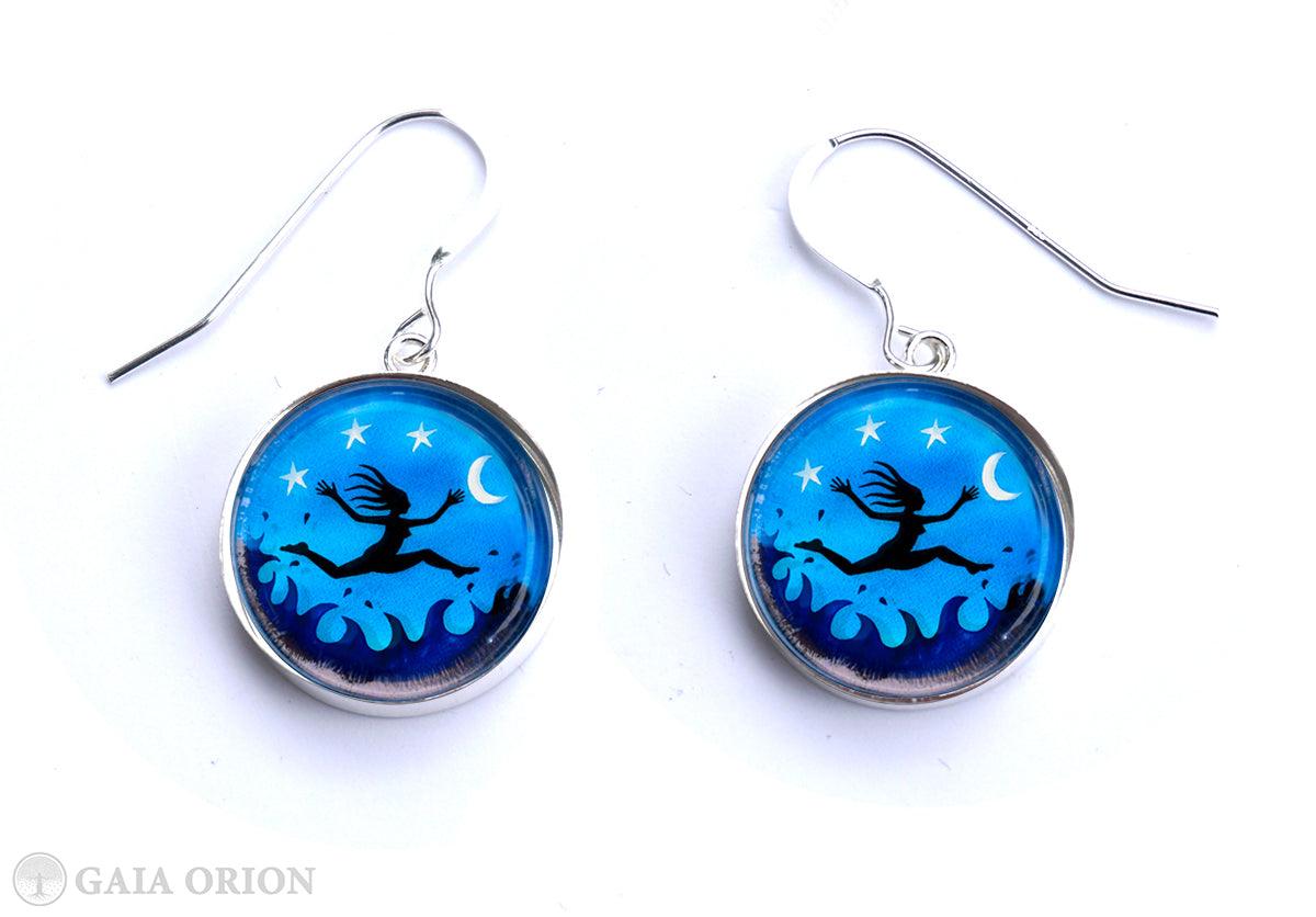 I am Free! Earrings featuring a blue night sky with stars and moon, platinum brass medallions, handmade in Canada.