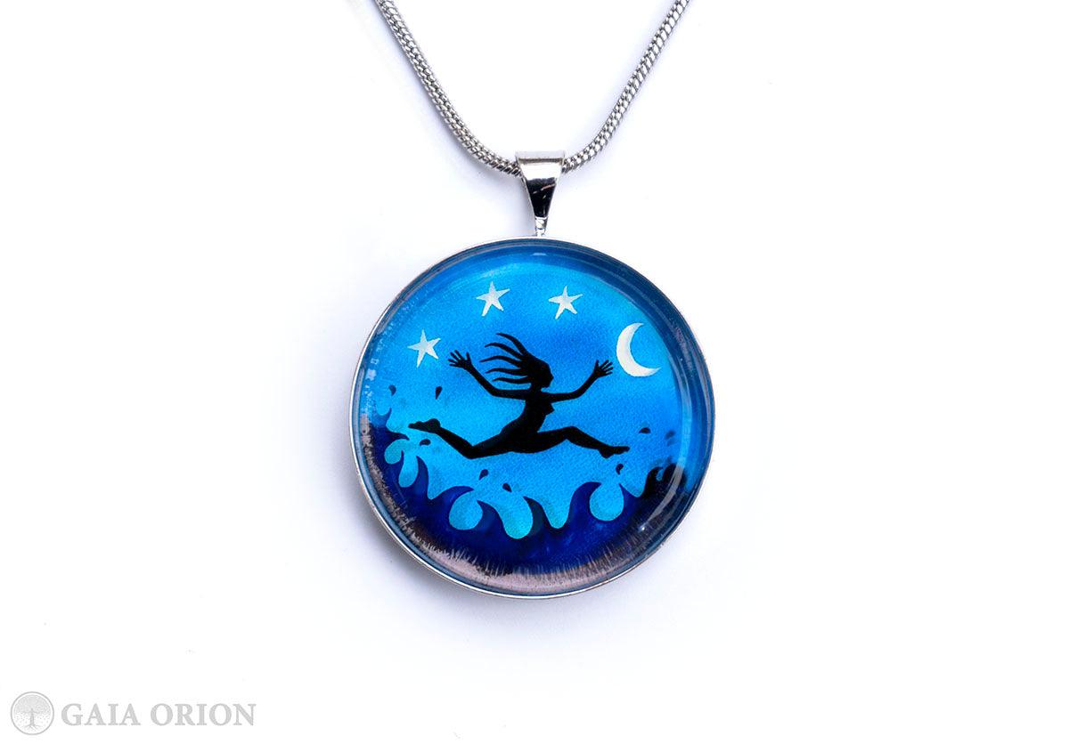 I am Free! Necklaces featuring a vibrant blue medallion with night sky and leaping figure design.