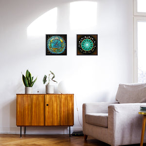 Two framed canvas print on a wall they are mandalas and spirals speaking about life cycles and the sacred feminine