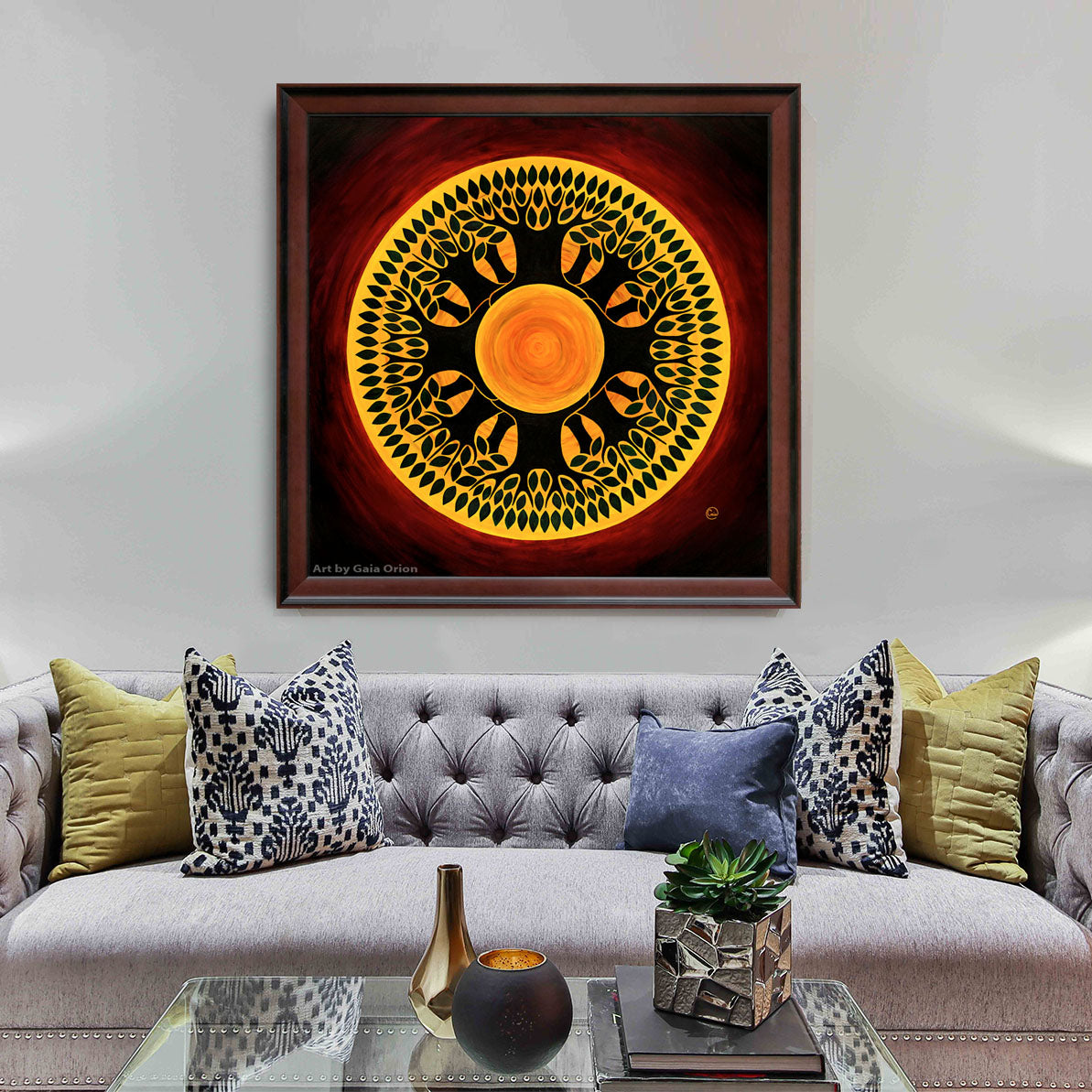 A framed painting of a deep red tree mandala with a yellow sun