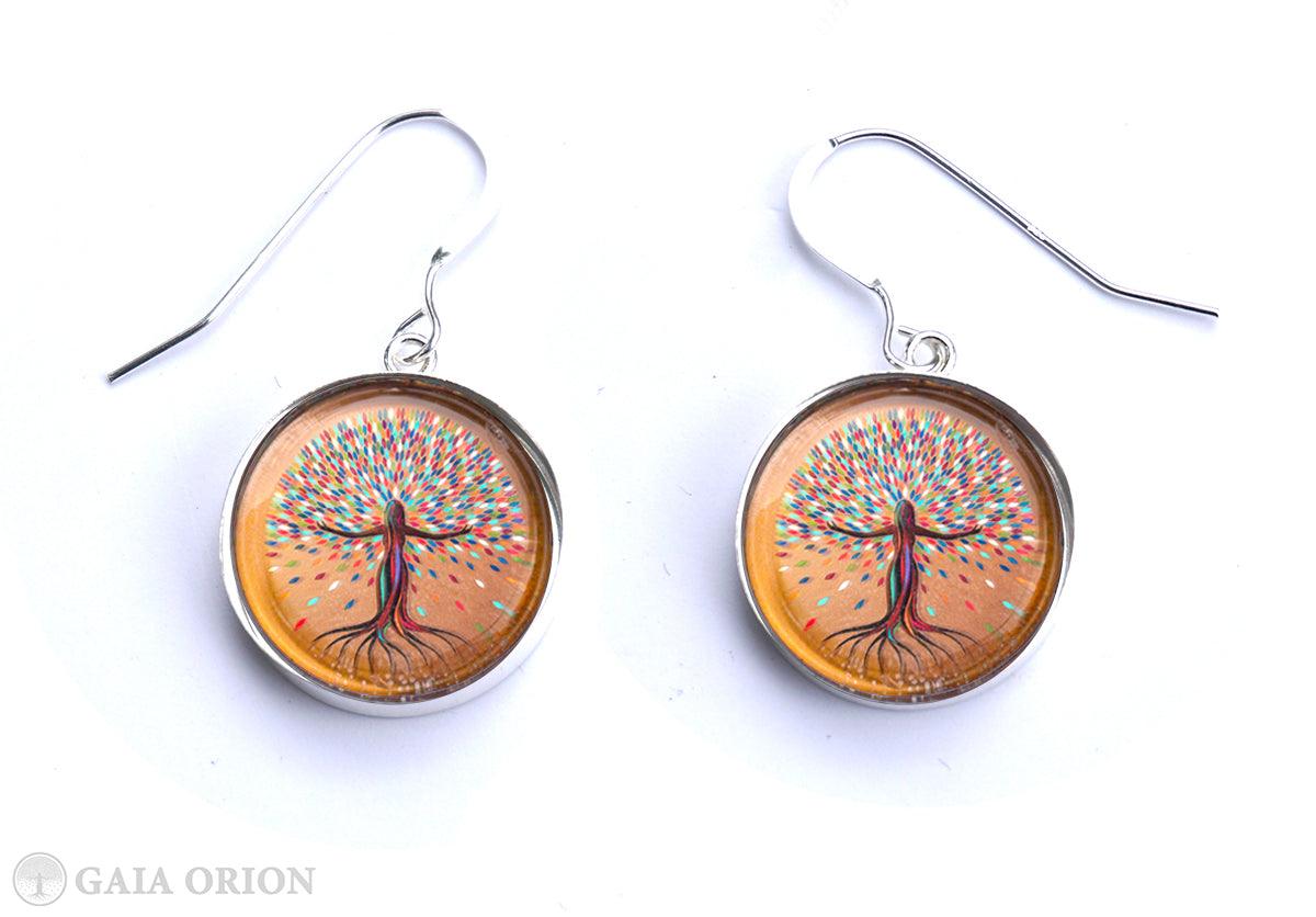 She Flourishes Earrings featuring colorful tree art on sterling silver medallions with durable glass dome, handmade in Canada.