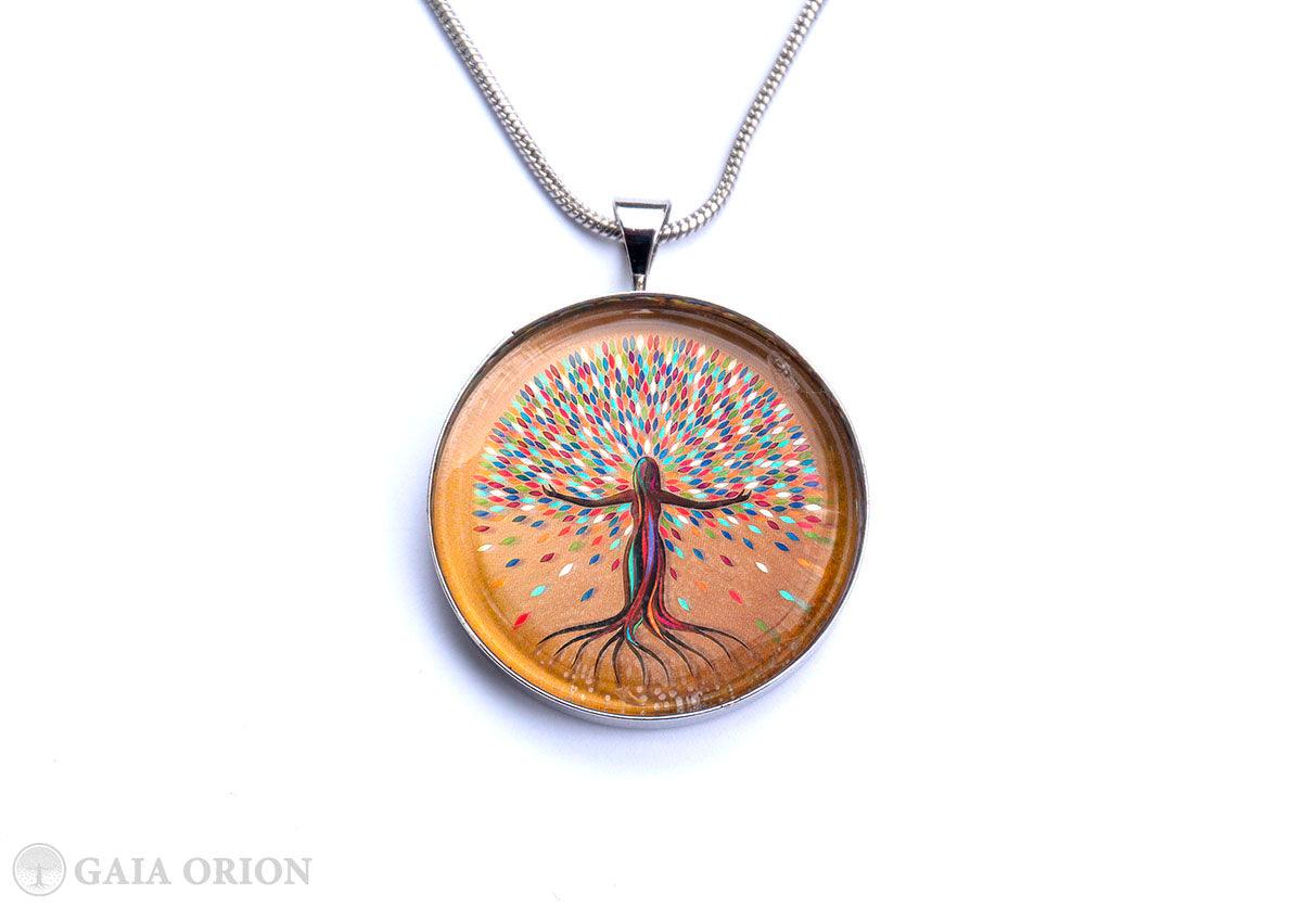 She Flourishes Necklaces featuring colorful tree of life art on sterling silver medallion with 16-inch snake chain.